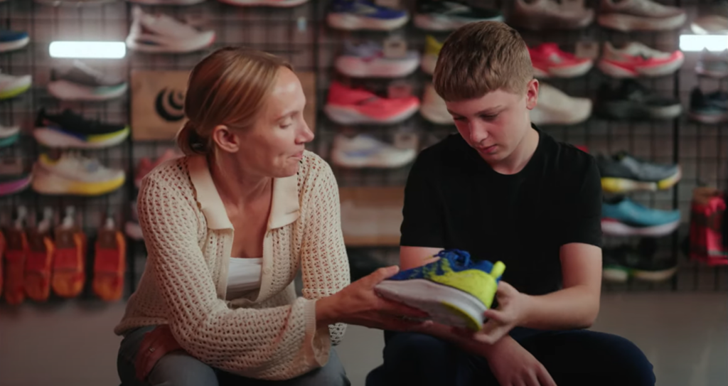 A woman talking to her son in a shoe shop