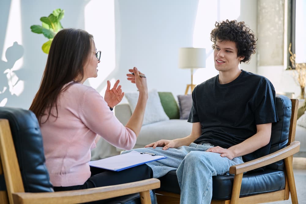 A therapist talking to a teenager